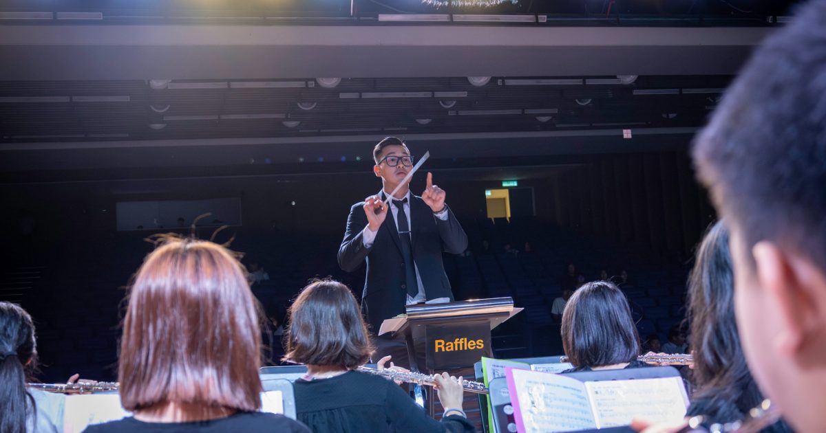 Band teacher directing an orchestra.